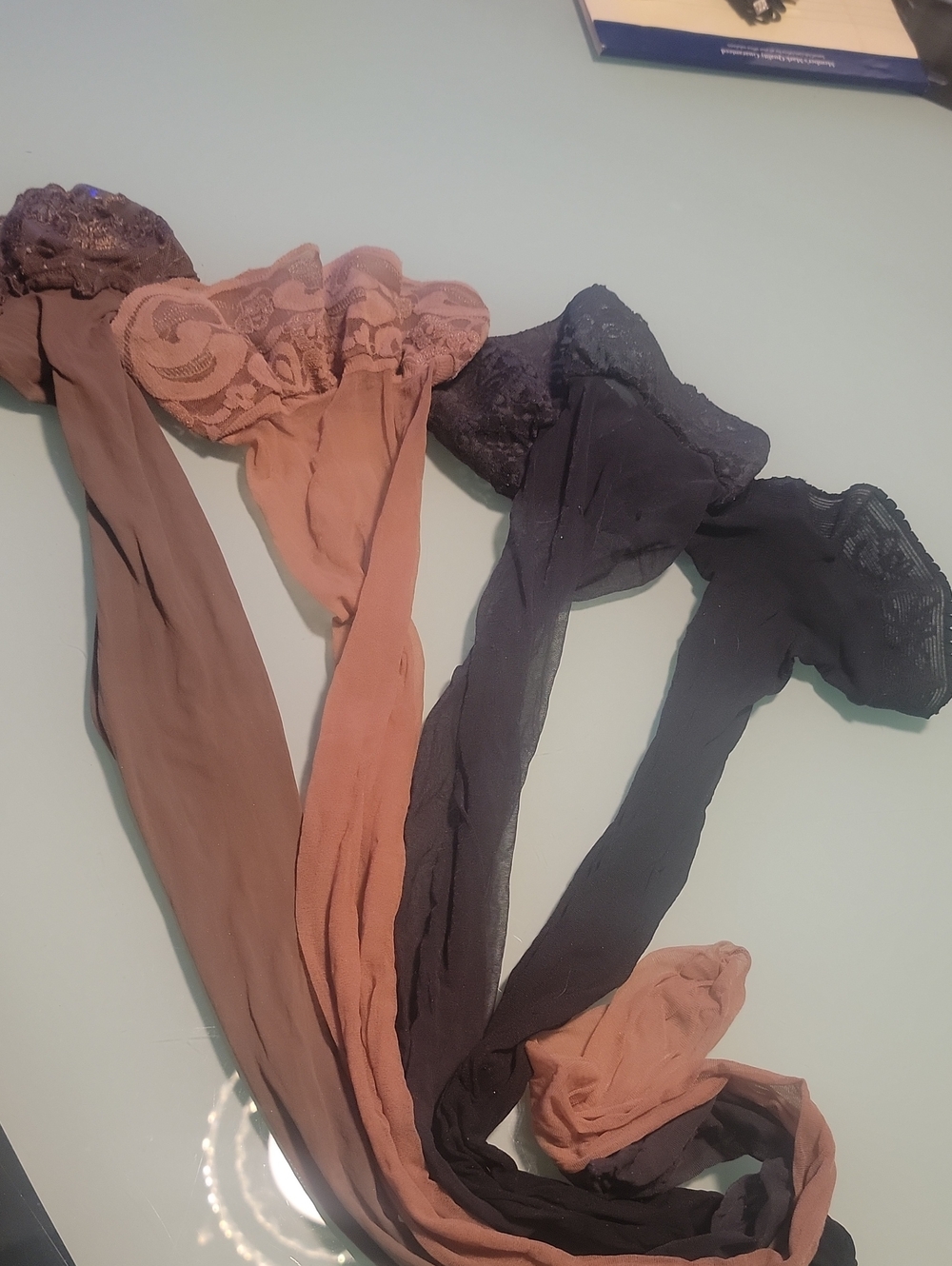 sheer thigh-high stockings featuring delicate lace trim. 4 Individual Legs.